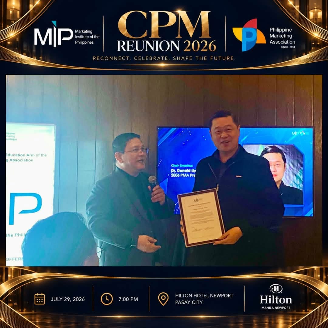 A framed certificate is presented during the CPM Reunion 2026 program.