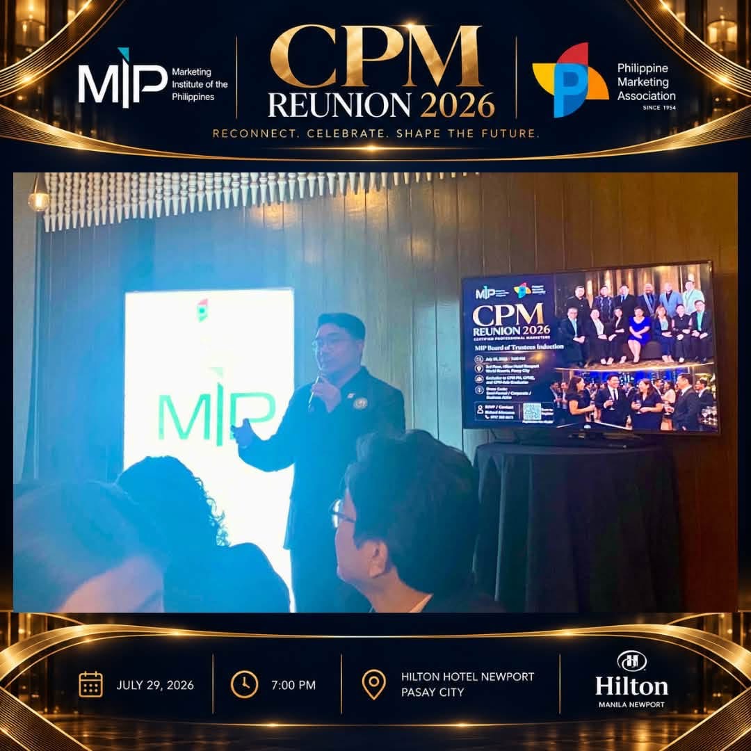 A presenter speaks to attendees beside the MIP display and CPM Reunion 2026 campaign artwork.