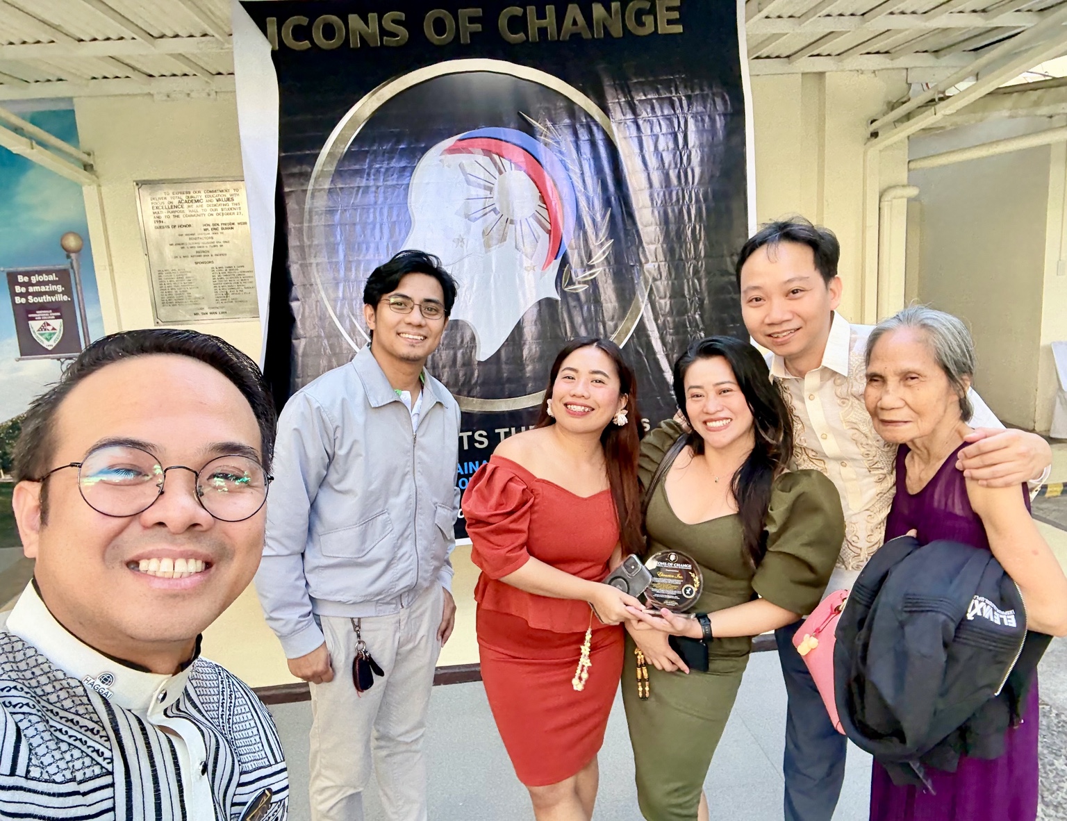 Community connections: Sir Next and fellow attendees beside the event banner. Icons of Change Metro Manila, April 27, 2025.