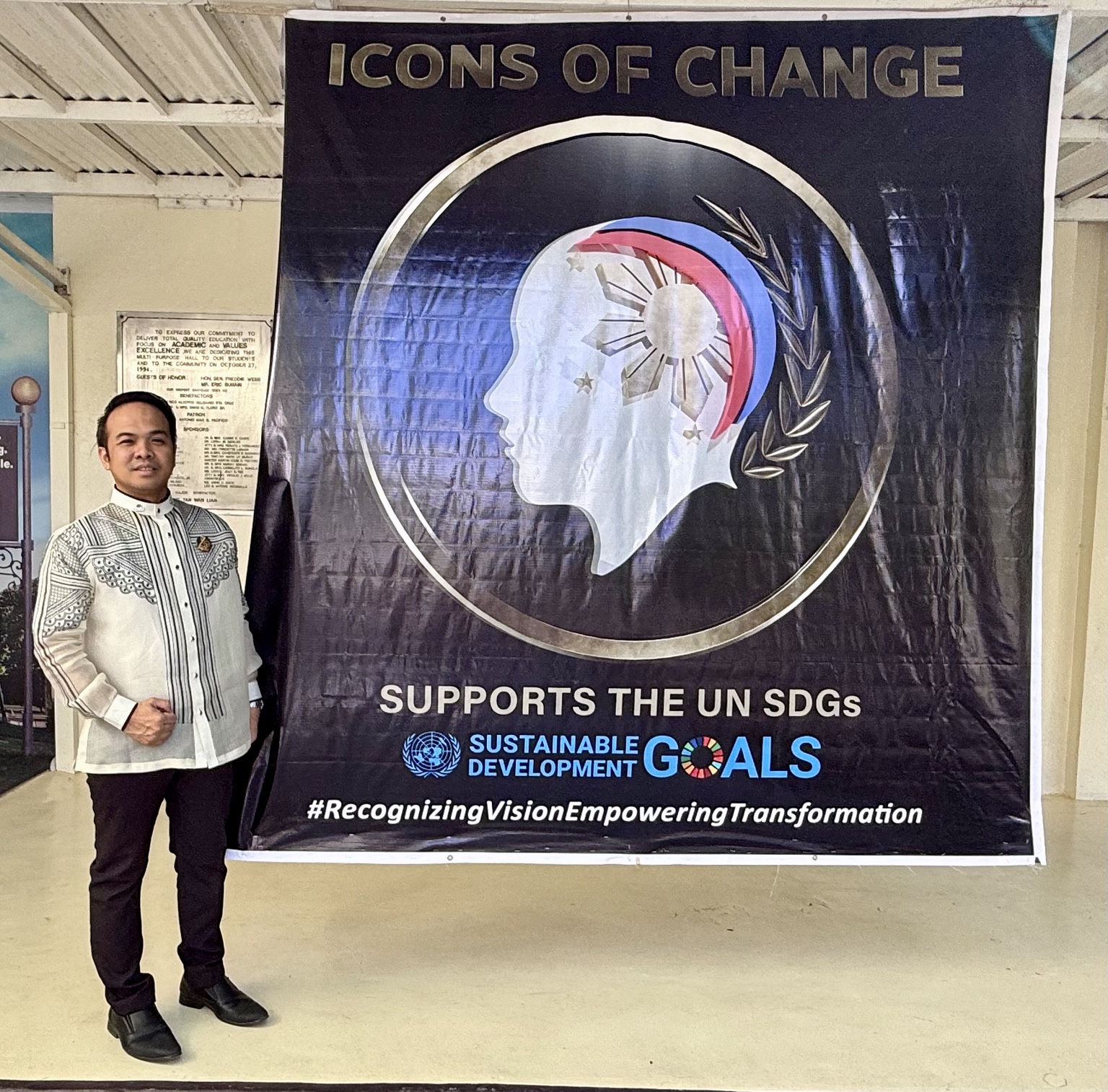 Sir Next beside the Icons of Change banner supporting the Sustainable Development Goals