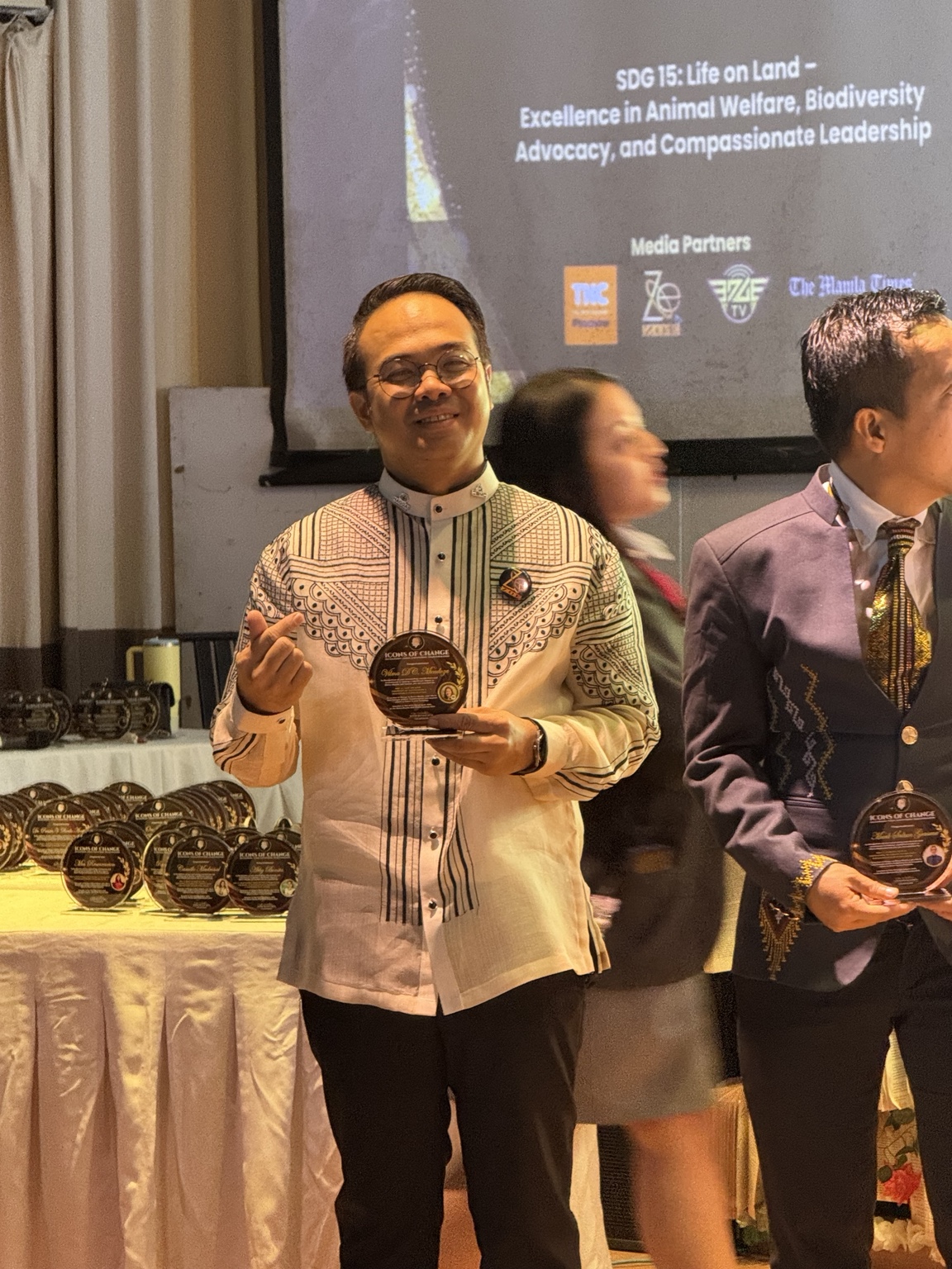 Sir Next holding his Icons of Change plaque during the recognition program
