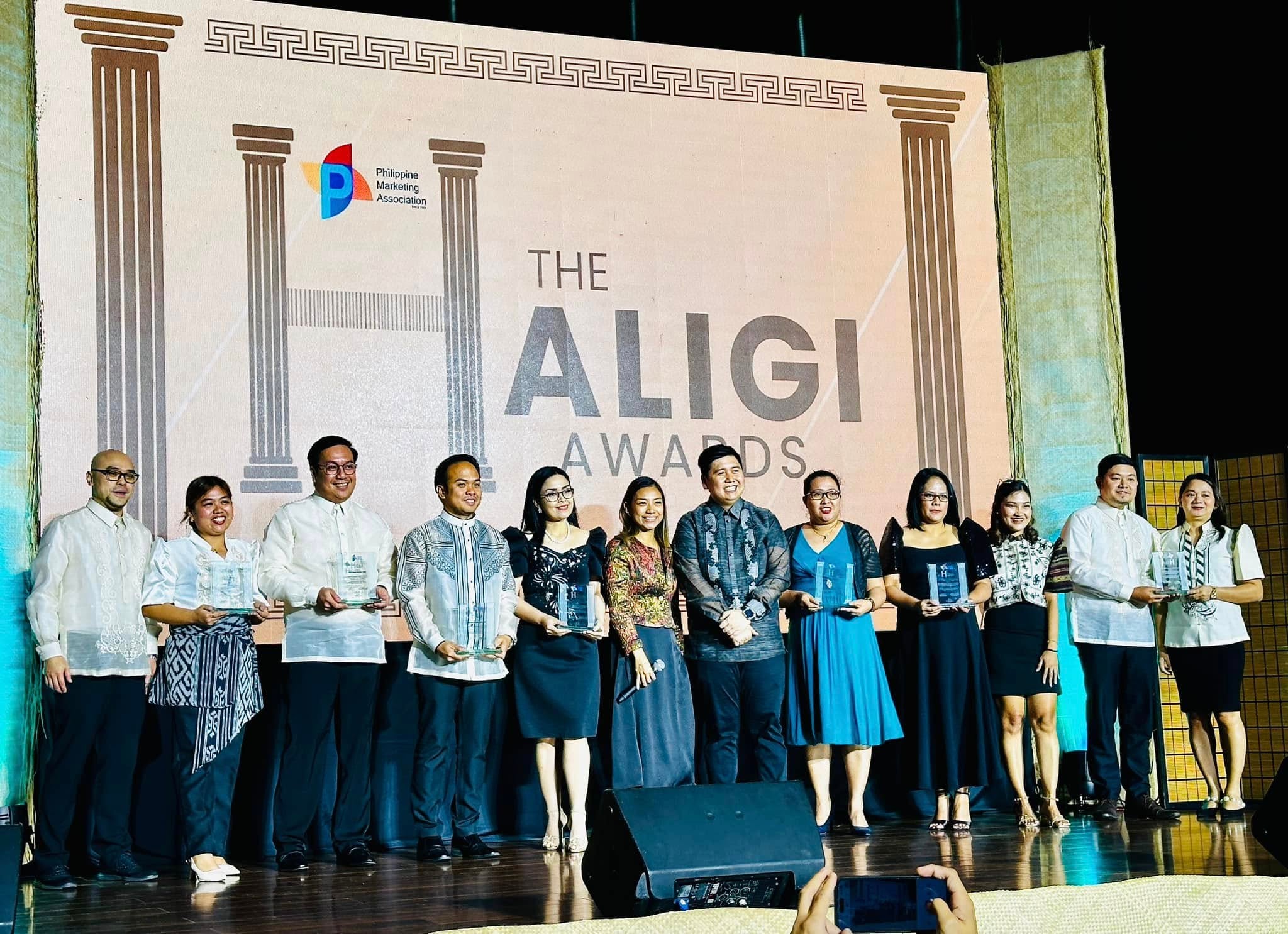 Sir Next stands with fellow Haligi Awards 2024 awardees on stage.